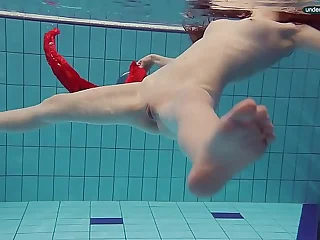 Red Dressed teen swimming with her eyes opened